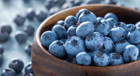 Fresh blueberries in wooden bowl close upの写真素材