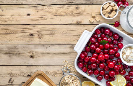 Raw ingredients for cooking cherry pie on wooden table top viewの写真素材