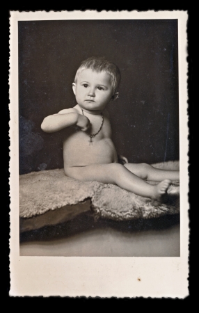 Baby with crucifix on his neck - circa 1935 の写真素材