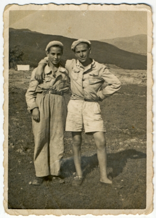 Two friends holding arms  in the mountainous countryside  - circa 1945の写真素材