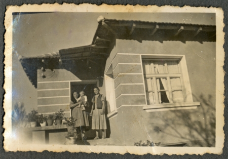 CIRCA 1955  the area Plovdiv - Two women on the porch of the house, one hugs babyの写真素材