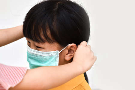 Asian little girl wear a medical mask to avoid contagious viruses. Stop the outbreak Coronavirus.のeditorial素材