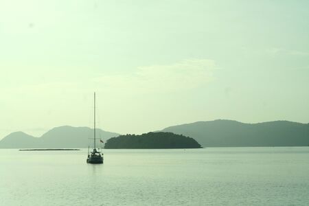 Sunny day at the sea. The islands at the background sail ship .. the sun reflect on the body of the sea ..の写真素材