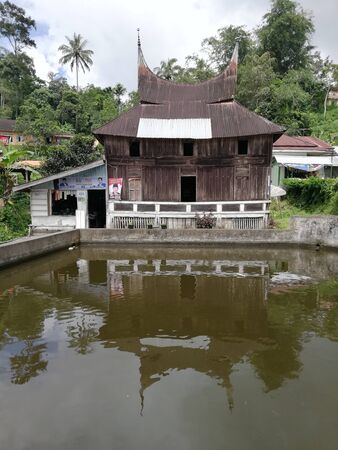 Old traditional Gadang house beside the pool