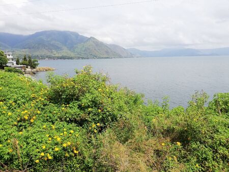 Scenic view of cloudy mountain by the lakeの写真素材