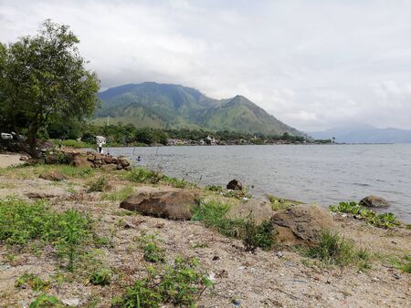 Scenic view of cloudy mountain by the lakeの写真素材