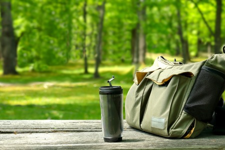 Water bottle and Shoulder bag. Bag and the bottle on the table.の写真素材