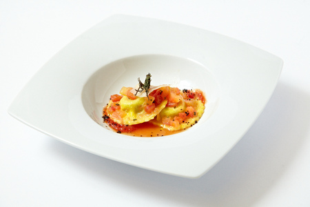 Ravioli with tomato sauce and parmesan isolated on whiteの写真素材