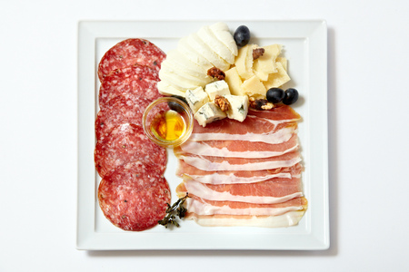 Assorted deli meats and cheese isolated on whiteの写真素材