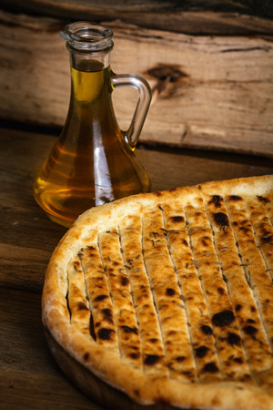 Garlic pizza bread on wood table with ingredientsの写真素材
