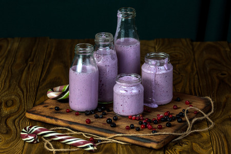 Set of blueberry smoothies in the different size jars on wood backgroundの写真素材