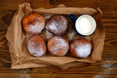 Donuts with cup of milk on wood background. Top viewの写真素材