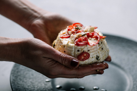 Ricotta cheese with spice in the women hands. Recipe stepsの写真素材