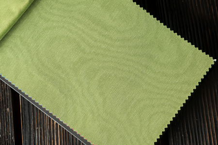 Color fabric samples palette on wood background. Green colors