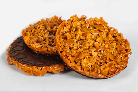 Nuts in caramel glazed with chocolate on the wooden rustic backgroundの写真素材