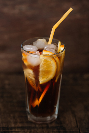 glass of orange lemonade on a wooden backgroundの写真素材