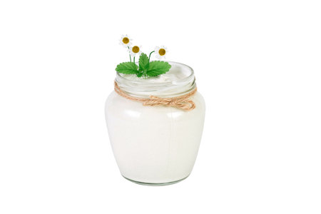 Open sour cream can with chamomileの写真素材