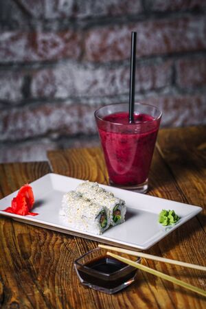 Sushi rolls and glass of  smoothies on wood background. Sushi menu. Japanese food.の写真素材