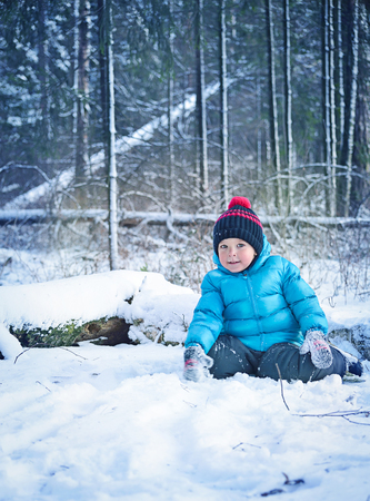 A small child in the winter forestの写真素材