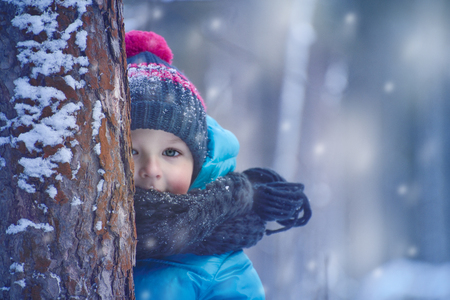 A small child in the winter forestの写真素材