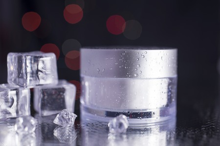 Black blank cream package on a dark background. 3d cosmetic make up cream. 3d rendering. Cosmetic cream container. Jar of cream for the face for your designの写真素材