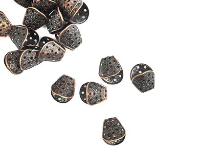 Metal frames for jewelry are scattered on a white background