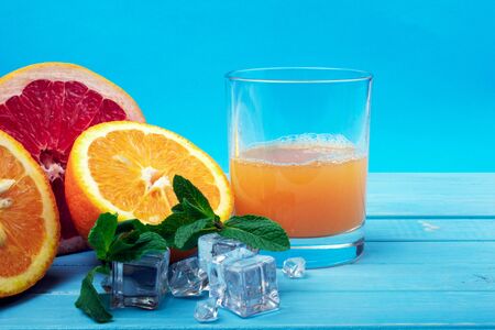 Orange juice with fruit on a blue backgroundの写真素材
