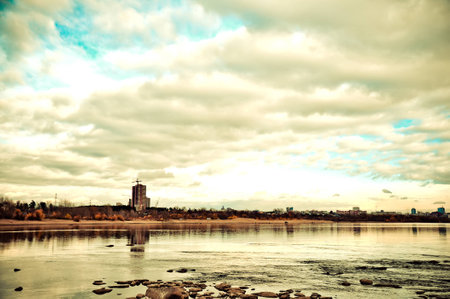 Stones on city river coast clouds on sky autumn russia