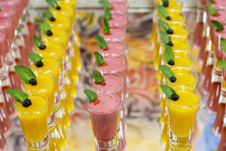 catring colored fruit mousse dessert in glass on mirror backgroungの写真素材
