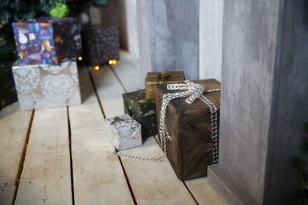 Christmas gifts under the Christmas tree with decorations in the morning, the interior in vintage...