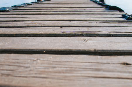 Old wooden pier on the sea on a summer evening at sunsetの写真素材