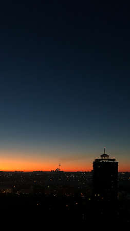 Night panoramic view of the city and the tower in the metropolis at sunriseの写真素材