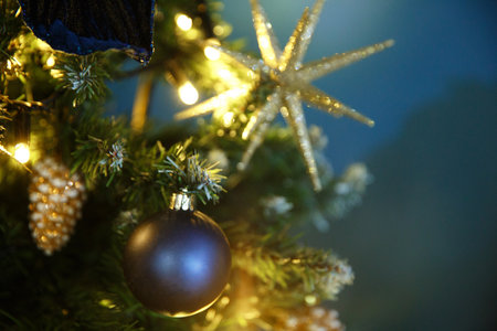 Bright New Year's Christmas lights, balls and toys hang on the tree and shimmer in different colors...