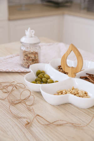 A festive plate served with nuts and other snacks in a bright Scandinavian kitchen in the morning