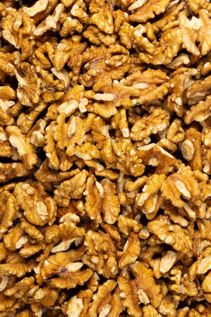 Peeled fresh golden walnuts close up in bulk top view for backgroundの写真素材