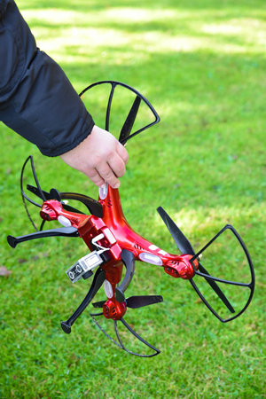 Red drone in hand