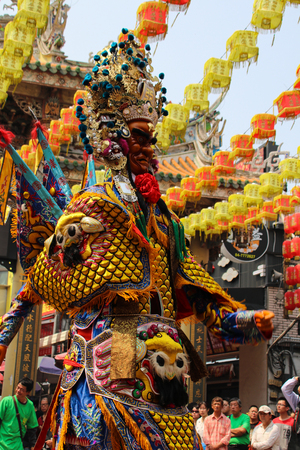 Changhua, Taiwan - MAR 25, 2215: Lukang Mazu Temple fair. The Taoist spirit medium or shaman takes the sword and flag in a traditional temple fair.のeditorial素材