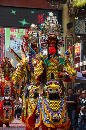 Changhua, Taiwan - MAR 25, 2207: Lukang Mazu Temple fair. The Taoist spirit medium or shaman takes the sword and flag in a traditional temple fair.のeditorial素材