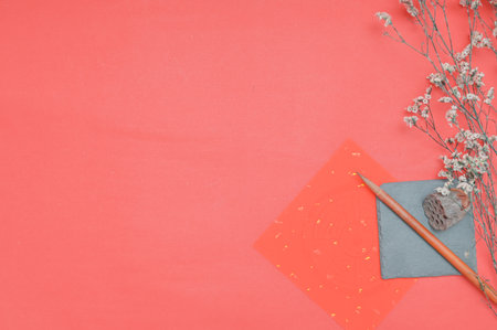 Creative flat lay top view mockup of workspace desk with copy space on red paper background. Minimal style.の写真素材