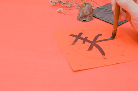 Writing chinese calligraphy with word meaning luck for lunar new year- The Chinese character FU (blessing) chun (spring) Chinese style calligraphy in lunar new yearの写真素材