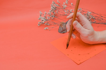 Writing chinese calligraphy with word meaning luck for lunar new year- The Chinese character FU (blessing) chun (spring) Chinese style calligraphy in lunar new yearの写真素材