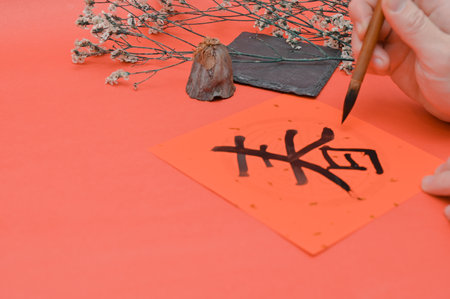 Writing chinese calligraphy with word meaning luck for lunar new year- The Chinese character FU (blessing) chun (spring) Chinese style calligraphy in lunar new yearの写真素材