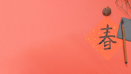 Writing chinese calligraphy with word meaning luck for lunar new year- The Chinese character FU (blessing) chun (spring) Chinese style calligraphy in lunar new yearの写真素材