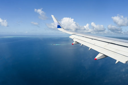 Clouds and sky as seen through window of an aircraft during flight