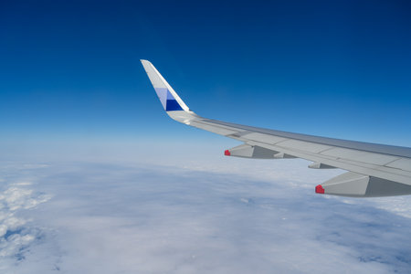 Clouds and sky as seen through window of an aircraft during flight