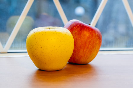 Japanese yellow and red apples on table close-upの写真素材