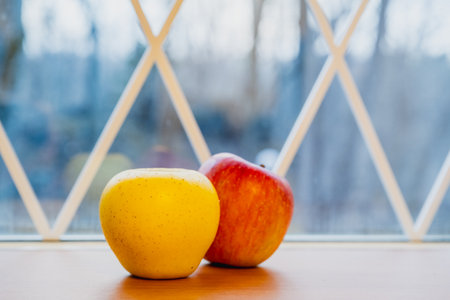 Yellow and red apples on table close-upの写真素材