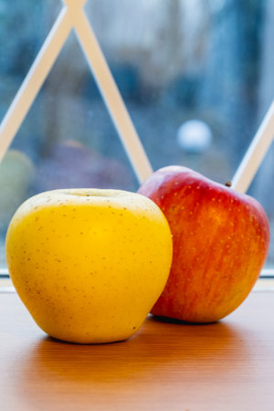 Japanese yellow and red apples on table close-upの写真素材