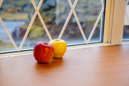 Japanese yellow and red apples on table close-upの写真素材