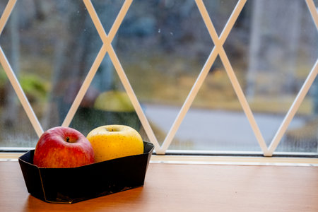 Japanese yellow and red apples on table close-upの写真素材